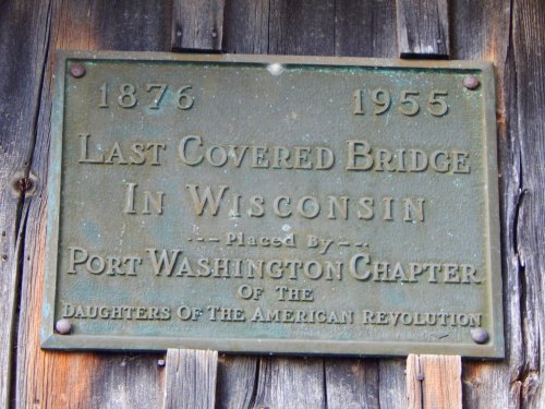 Plaque commemorating the last covered bridge in Wisconsin, placed by the Port Washington Chapter of the Daughters of the American Revolution.