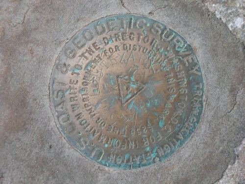 Bronze survey marker embedded in stone, inscribed with "U.S. Coast & Geodetic Survey" and other survey details.
