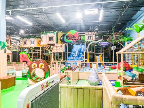 Colorful indoor playground with slides, climbing structures, and play areas designed for children.