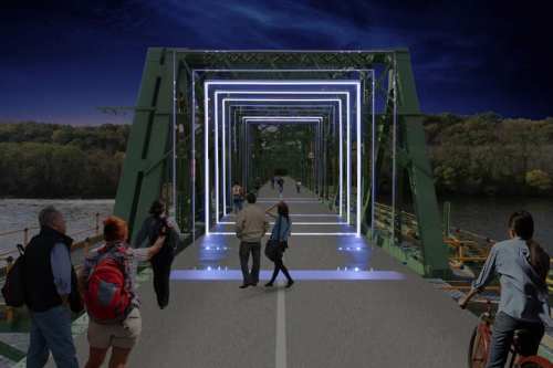 A vibrant bridge at night, illuminated with glowing frames, with people walking and enjoying the scenic view.