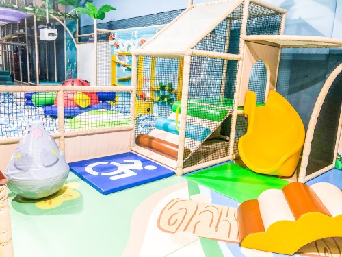 Colorful indoor playground with slides, climbing structures, and soft play areas for children.