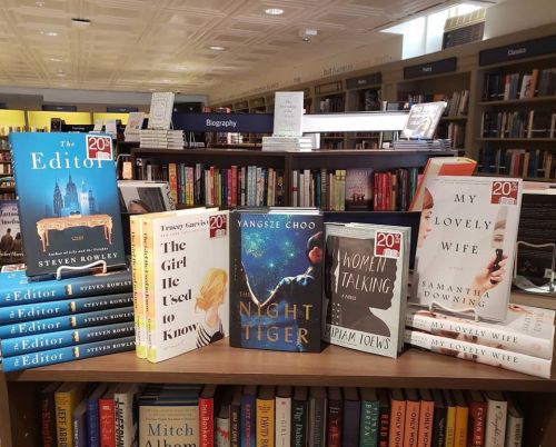A display of books on a shelf, featuring titles like "The Editor," "The Night Tiger," and "Women Talking."