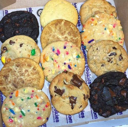 A box of assorted cookies, including chocolate chip, sugar, and colorful sprinkle cookies, arranged neatly.