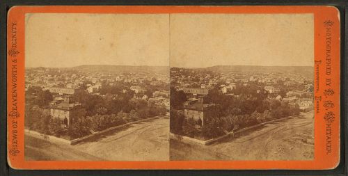 Historic stereoscopic view of Leavenworth, Kansas, showcasing a panoramic cityscape with buildings and hills in the background.