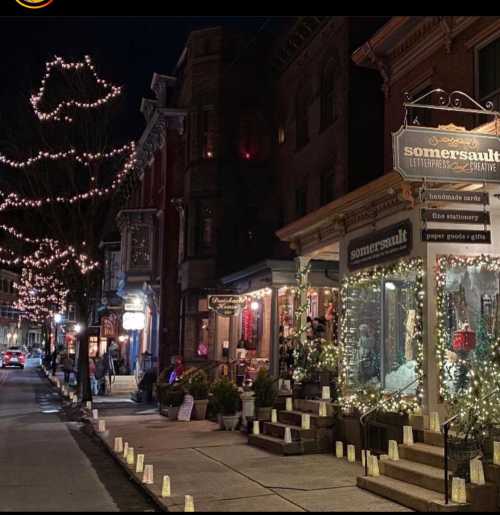 A charming street scene at night, featuring a shop adorned with lights and festive decorations.