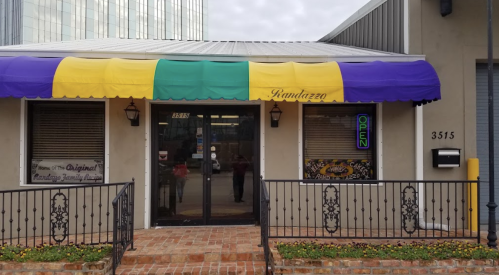 Exterior of Randazzo's with a colorful awning, open sign, and brick steps leading to the entrance.