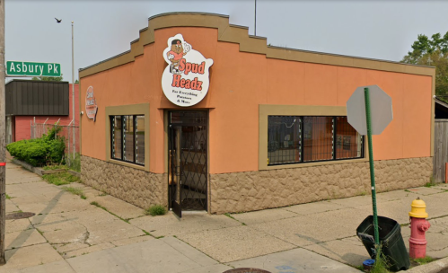 Exterior of Spud Headz restaurant, featuring a colorful sign and large windows, located at Asbury Park.