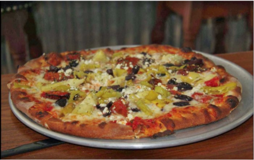 A freshly baked pizza topped with olives, feta cheese, and green peppers on a metal serving tray.