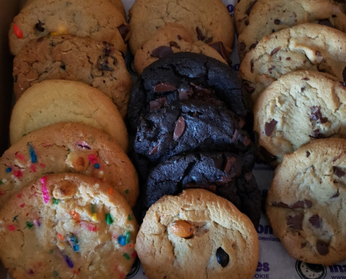 A box of assorted cookies, including chocolate chip, funfetti, and dark chocolate varieties.