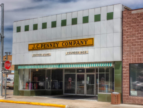 Historic J.C. Penney Company storefront with green and white awning, featuring "Founded 1902" sign.