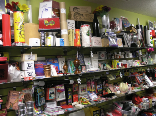 A colorful display of various magic tricks and novelty items on shelves in a store.