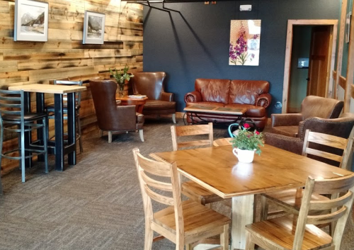 Cozy café interior with wooden walls, leather seating, and tables, creating a warm and inviting atmosphere.