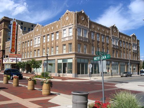 Historic building with ornate architecture at the corner of E 12th St and Meridian St, featuring a marquee sign.