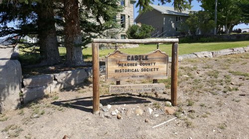 Sign for the Meagher County Historical Society, detailing hours and information about the site.
