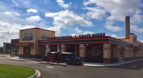 Exterior of Ford's Garage restaurant featuring vintage gas pumps and a sign for fine burgers and craft beers.