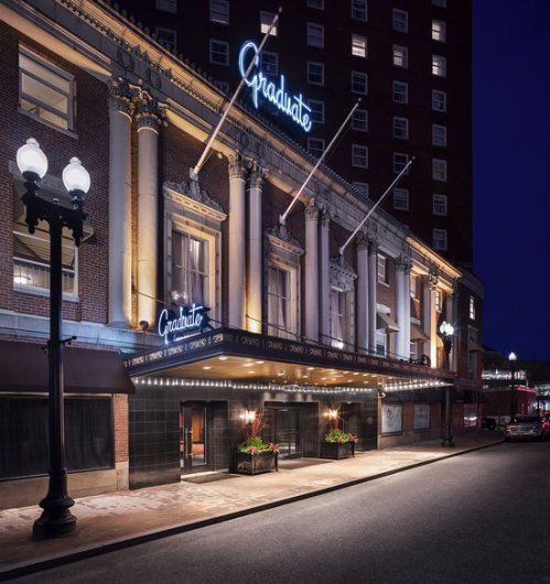 The Graduate theater illuminated at night, featuring classic architecture and a marquee sign.