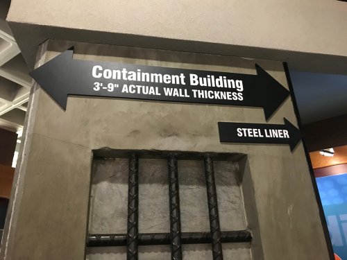 Signage indicating directions to the Containment Building and information about wall thickness and steel liner.