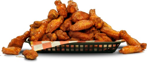 A large pile of saucy chicken wings in a black basket lined with checkered paper.