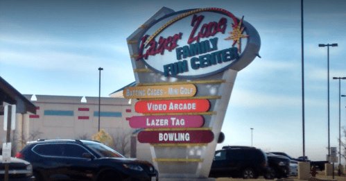 Sign for Lazer Zone Family Fun Center featuring activities like mini-golf, arcade, laser tag, and bowling.