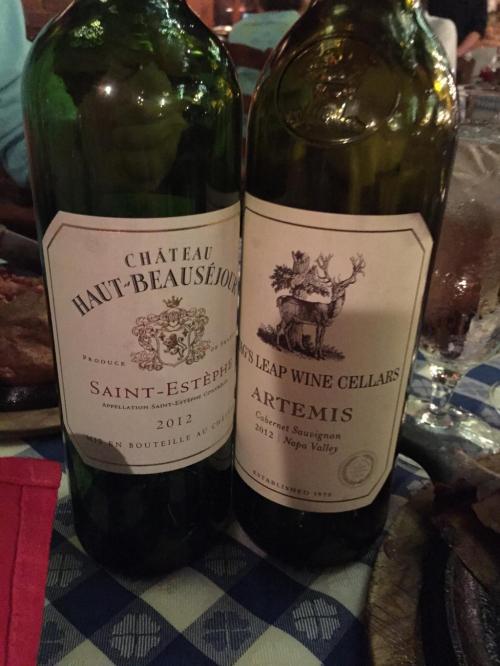 Two wine bottles on a table: one from Château Haut-Beauséjour and the other from Stag's Leap Wine Cellars, both vintage 2012.