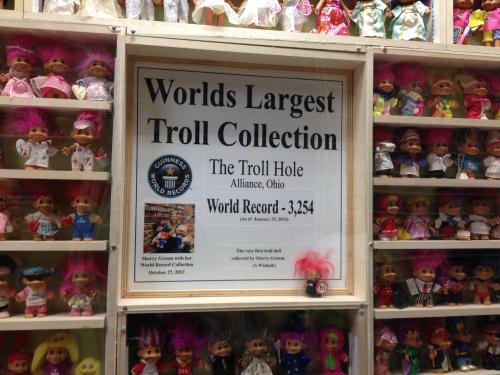 Sign displaying "World's Largest Troll Collection" with details about the collection and a photo of Sherry Groves.