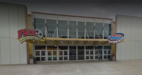 Entrance of a recreational center featuring "Flix Sports Bar & Grill" and "National Air Trampoline Park" signs.