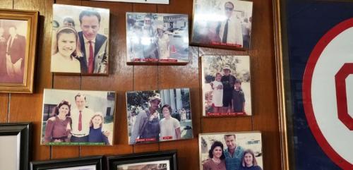 A collage of vintage photos on a wooden wall, featuring families and individuals at various events.