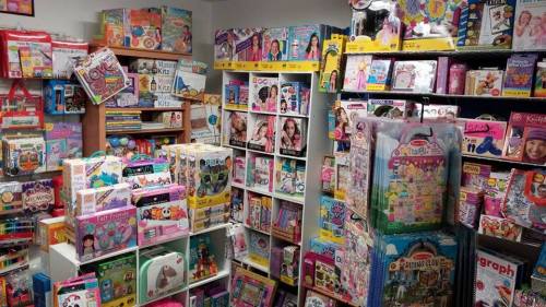 A colorful toy store filled with shelves of various toys, games, and educational products for children.