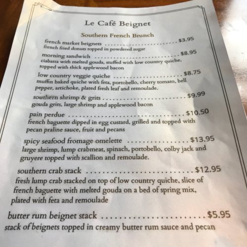 Menu for Le Café Beignet featuring Southern French brunch items and prices, including beignets, omelettes, and crab stack.