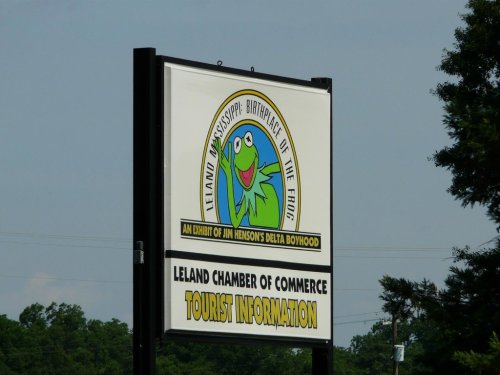 Sign for the Leland Chamber of Commerce featuring Kermit the Frog, promoting the birthplace of the Delta blues.