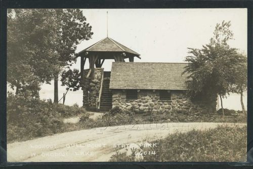 Historic stone lookout tower at Gull Point State Park, surrounded by trees and a winding path.