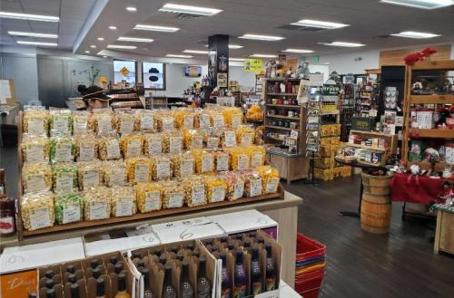 A colorful display of popcorn bags in a store, with shelves of various products and a welcoming atmosphere.