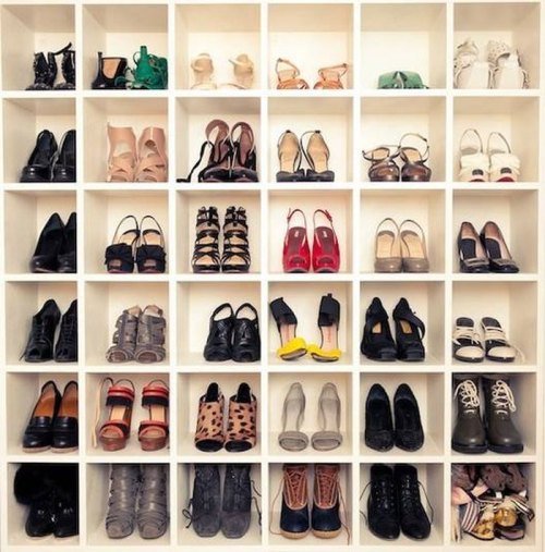 A neatly organized shoe display with various styles and colors arranged in cubby-like shelves.