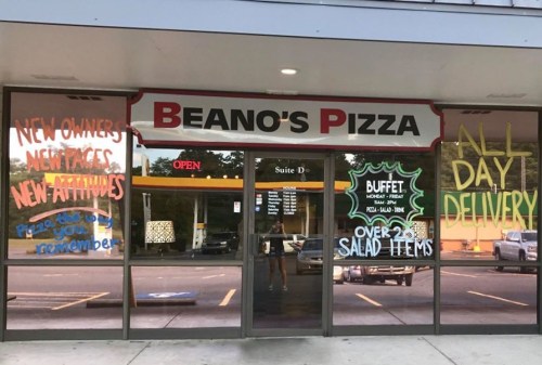 Front of Beano's Pizza with colorful signs announcing new owners, buffet, and all-day delivery.