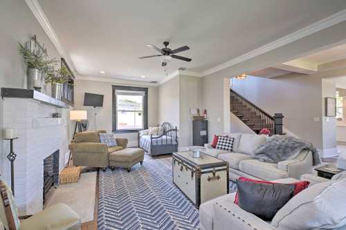 Cozy living room with a fireplace, comfortable seating, and a patterned rug, featuring a mix of modern and vintage decor.
