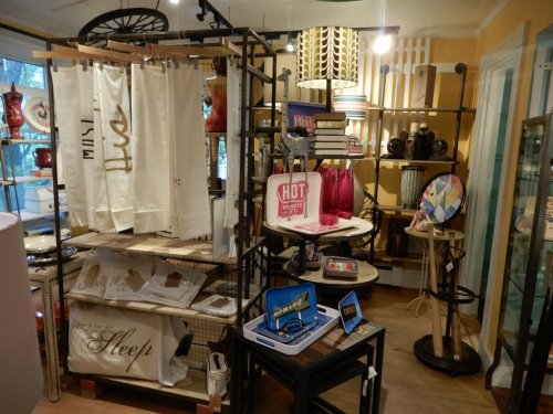 A cozy home decor store filled with various decorative items, including lamps, towels, and colorful accessories.