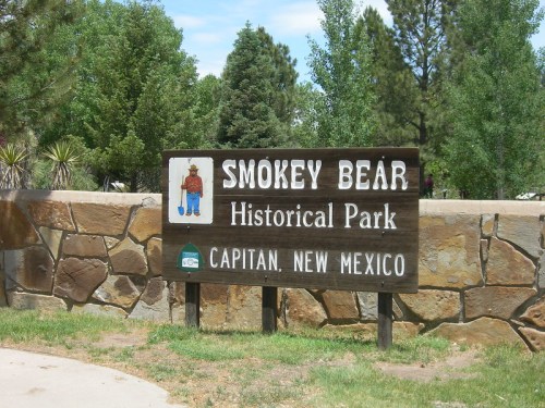 Sign for Smokey Bear Historical Park in Capitan, New Mexico, featuring an illustration of Smokey Bear.