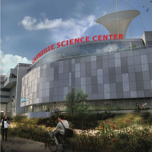 Exterior view of the Carnegie Science Center, featuring modern architecture and a large sign, with people walking and biking nearby.