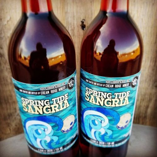 Two bottles of Spring Tide Sangria from Cream Ridge Winery, featuring colorful labels with ocean wave designs.