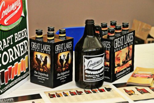 A display of Great Lakes Brewing Co. beer boxes and a growler, alongside a sign for Consumer's Beverage.