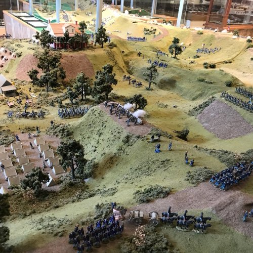 A detailed model depicting a historical battle scene with soldiers, tents, and terrain features.