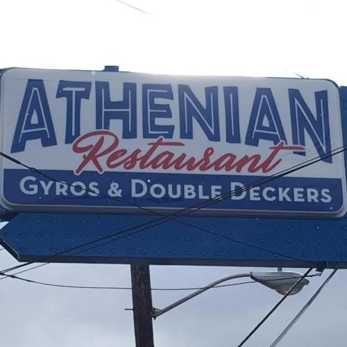 Sign for Athenian Restaurant featuring "Gyros & Double Deckers" in bold letters against a blue background.
