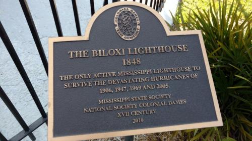 Plaque detailing the Biloxi Lighthouse, built in 1848, noting its survival of several hurricanes.