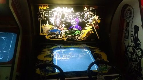 An arcade game titled "Death Race" featuring two cartoonish drivers and vintage racing graphics.