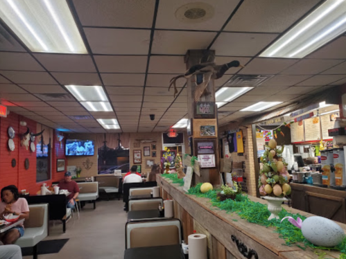 A cozy diner interior with booths, a decorated counter, and festive Easter-themed decor. Customers are enjoying their meals.