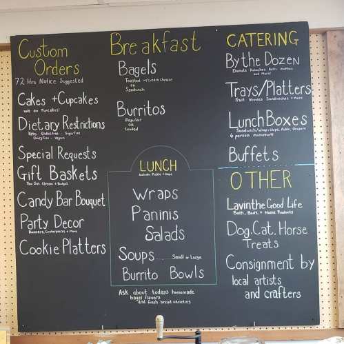 Chalkboard menu featuring custom orders, breakfast items, lunch options, catering services, and other offerings.