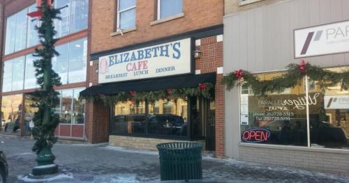 Exterior of Elizabeth's Cafe, decorated for the holidays, with a sign indicating breakfast, lunch, and dinner services.