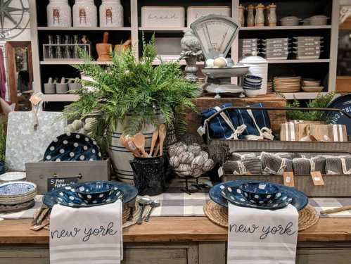 A beautifully arranged table setting with blue polka dot plates, utensils, and decorative items in a cozy kitchen display.
