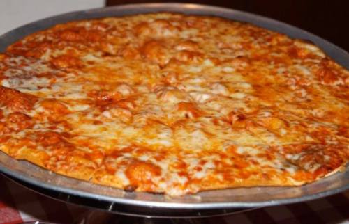 A freshly baked cheese pizza on a metal serving tray, with a golden crust and melted cheese.