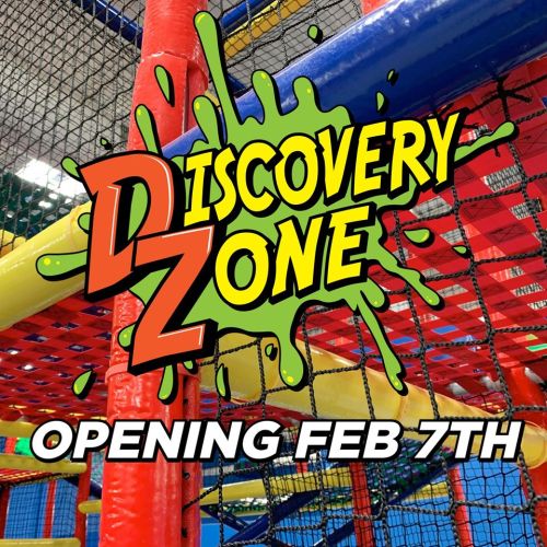 Colorful indoor play area with netting and vibrant structures, promoting the opening of Discovery Zone on February 7th.